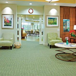 A well-decorated lobby area featuring comfortable seating and artwork on the walls.