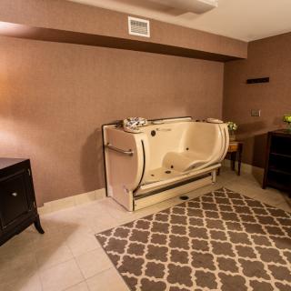 A modern bathroom featuring a walk-in tub and stylish decor.