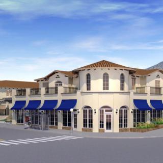 A commercial building with blue awnings on a street corner.
