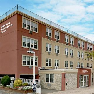 A modern multi-story building with a combination of brick and beige exterior, featuring numerous windows and a well-maintained facade.