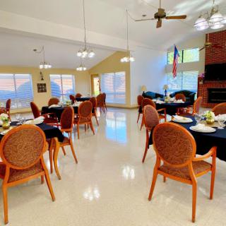 A cozy dining area featuring well-set tables and a panoramic view.
