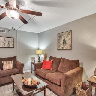 Cozy living room with brown sofas and modern decor.
