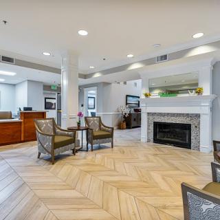 A modern lobby with a fireplace and comfortable seating.