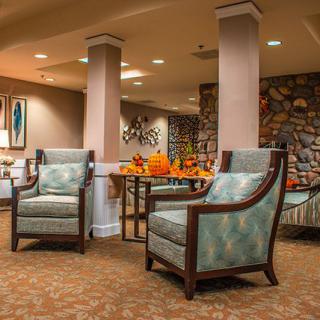 A cozy lounge area with armchairs and warm lighting.