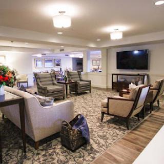 A cozy and modern lounge area with comfortable seating, a television, and decorative elements.