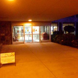 The illuminated entrance to a building at night, showcasing the welcoming atmosphere.