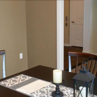 A cozy dining area with a table, chairs, and decorative elements.