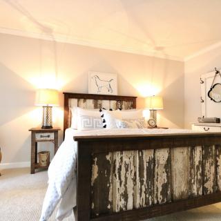 A cozy bedroom with rustic wooden furniture and warm lighting.