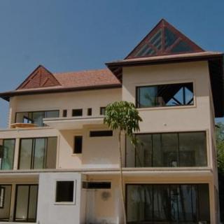 A modern residential house with large windows and unique architectural design.