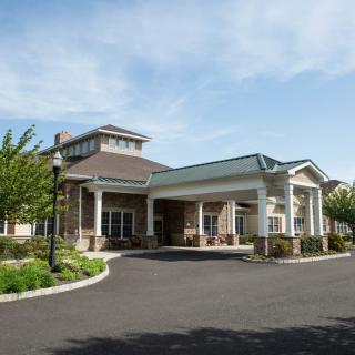 A modern building with a welcoming entrance and well-maintained landscaping.