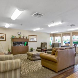 A cozy lounge area with comfortable seating and ample natural light.