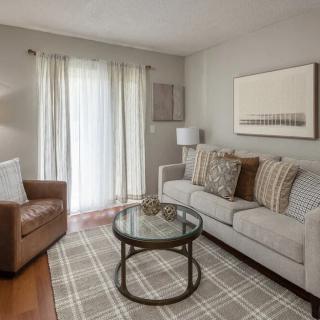 A cozy living room with a sofa, armchair, and coffee table.