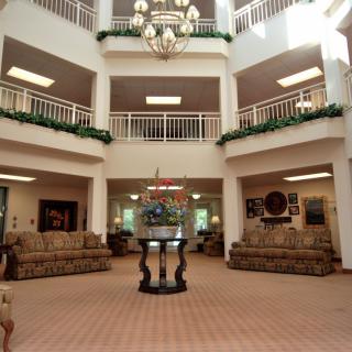 Spacious lobby area with elegant chandeliers and comfortable seating.