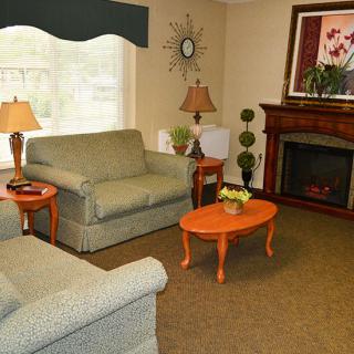 A cozy living room with comfortable seating and a warm fireplace.