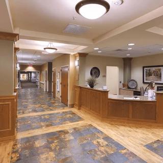 A spacious and elegantly designed lobby area with a reception desk and hallway.