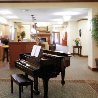 An elegant lobby featuring a grand piano and comfortable seating.