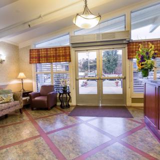 A welcoming lobby interior with seating and glass entrance doors.