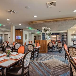 A well-decorated restaurant dining area with neatly arranged tables and chairs.