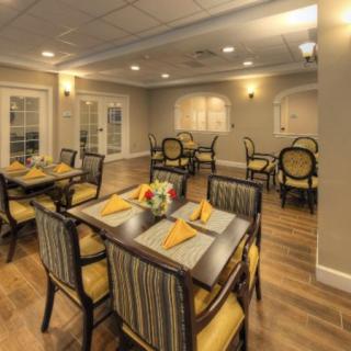 An elegant dining room with multiple tables set for a meal.