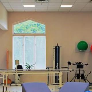 A rehabilitation center equipped with exercise machines and therapy tools.
