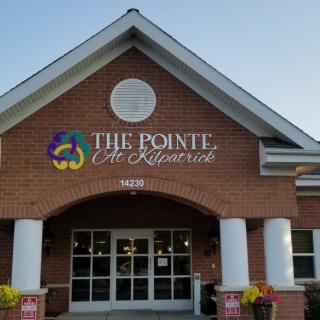 Front view of a commercial building with the sign 'The Pointe at Kilpatrick' above the entrance.