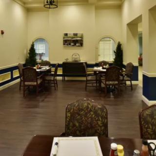 An indoor dining area with neatly arranged tables and chairs, featuring elegant decor.