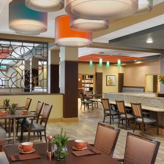 A modern restaurant dining area with stylish seating and unique ceiling lights.