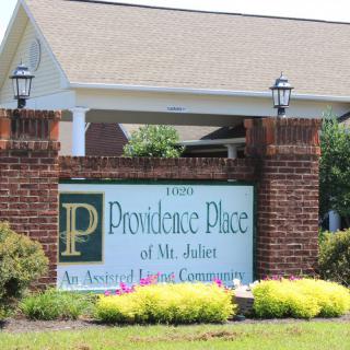 Entrance sign for Providence Place of Mt. Juliet, surrounded by greenery.