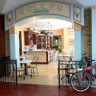 A charming cafe featuring inviting seating arrangements and a bicycle parked outside.