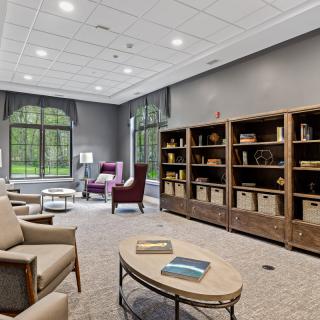 A modern library interior with comfortable seating and large bookshelves.