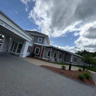 A modern building set against a cloudy sky.