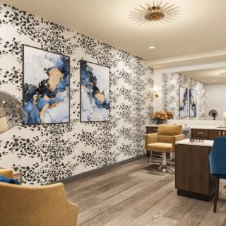 A stylish salon featuring modern artwork and sophisticated decor with comfortable seating.