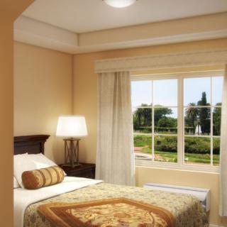 A cozy bedroom with a large window providing a view of the outdoors.