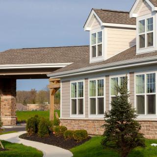 A modern residential house with large windows and well-maintained landscaping.