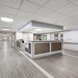 A modern and clean hospital reception area with a central desk.