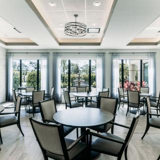 A modern dining area with ample natural light and elegant furniture.