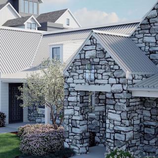 A beautiful stone exterior house with a landscaped front yard.