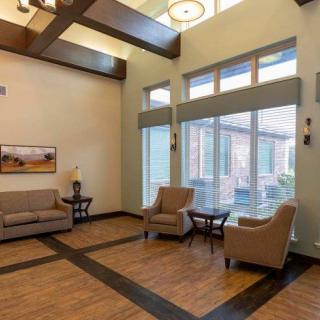 A modern lobby interior with comfortable seating and large windows.