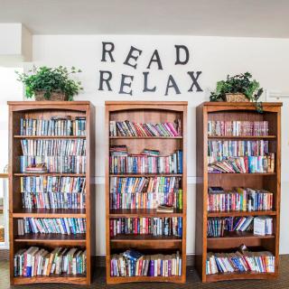 A cozy library corner with bookshelves inviting you to read and relax.