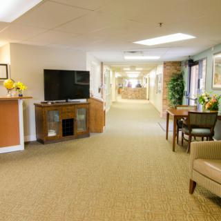 A cozy hallway with a TV area and comfortable seating.