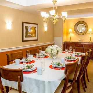 A beautifully set dining room table with elegant decor and ambient lighting.