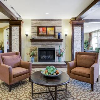 A cozy living room with a fireplace and comfortable seating.