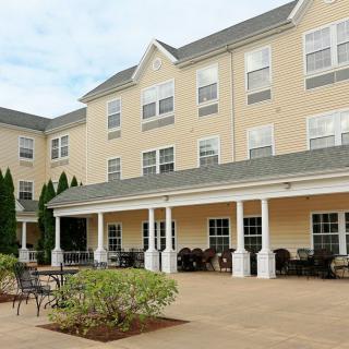 A residential building with a spacious patio and porch area.