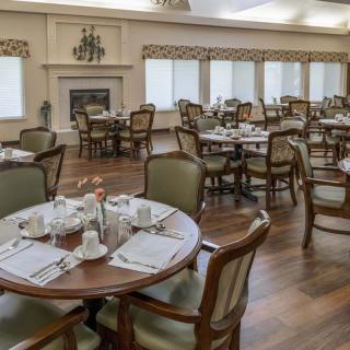 An elegant dining room with neatly arranged tables and chairs, ready for guests.