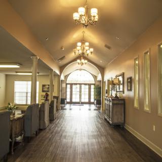 A beautifully designed hallway with elegant chandeliers and a welcoming entrance.