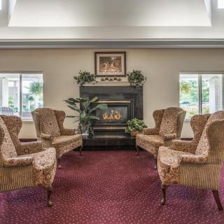 A cozy lobby with a fireplace and comfortable seating arrangement.