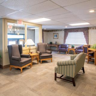 A cozy lounge area with comfortable seating and natural light.