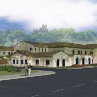 A depiction of a building complex with a Spanish-style architectural design, situated along a street with nearby trees and pedestrians.
