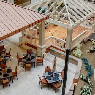 An inviting outdoor dining area with tables and chairs set up on a patio.