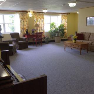 A spacious living room with comfortable furniture and natural light.